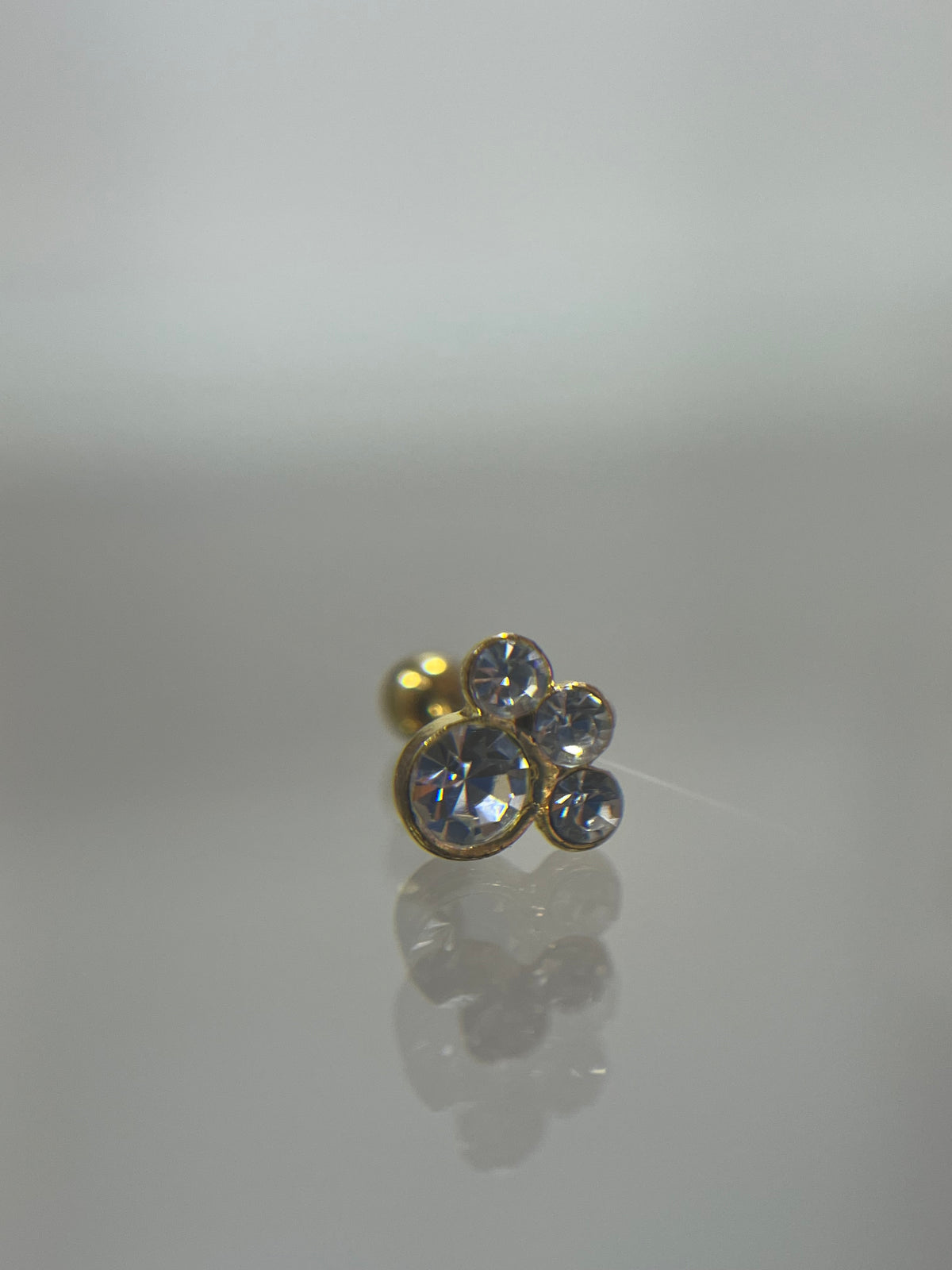 Piercing titanium huella dorado (cierre bolilla)